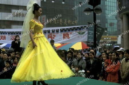 People at a fashion show at the main square in the city of Chongqing in the province of Sichuan in china in east asia. 