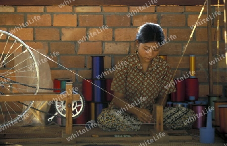 a weaving women working in a Farmer village outside of the city of phnom penh in cambodia in southeastasia. 