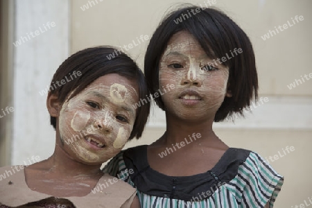 a girl with the thanaka cosmetic at the Mahagandayon Monastery in Amarapura near the City of Mandalay in Myanmar in Southeastasia.
