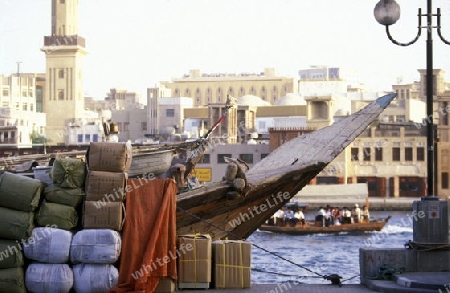 Import and export goods at the harbour at the Dubai creek in the old town in the city of Dubai in the Arab Emirates in the Gulf of Arabia.