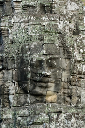 Stone Faces the Tempel Ruin of Angkor Thom in the Temple City of Angkor near the City of Siem Riep in the west of Cambodia.