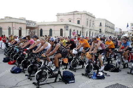 a fitness class in the old Town of Siracusa in Sicily in south Italy in Europe.