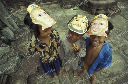 childern in a temple in Angkor at the town of siem riep in cambodia in southeastasia. 