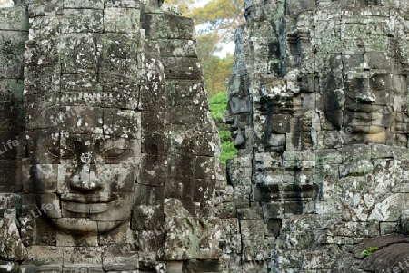 Stone Faces the Tempel Ruin of Angkor Thom in the Temple City of Angkor near the City of Siem Riep in the west of Cambodia.