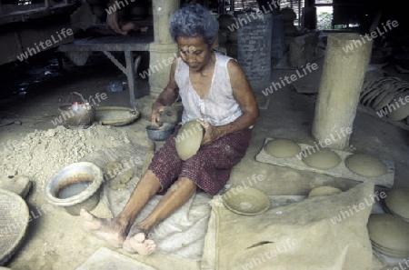 a women works in a potery factory in the city of phnom penh in cambodia in southeastasia. 