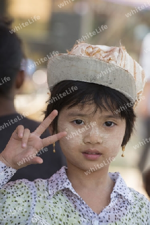a girl at a Food market in the City of Mandalay in Myanmar in Southeastasia.