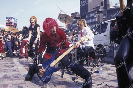 a Japanese Youth Punk Band plays on a square in the City of Tokyo in Japan in Asia,



