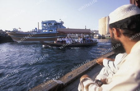 a city boat and ferry on the Dubai creek in the old town in the city of Dubai in the Arab Emirates in the Gulf of Arabia.