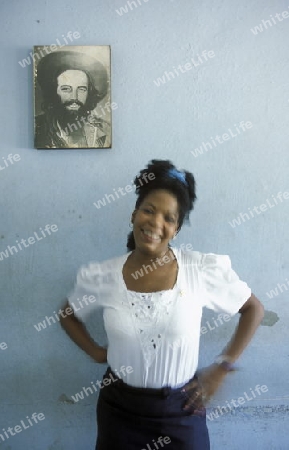 a women in house in the city centre in the city of Santiago de Cuba on Cuba in the caribbean sea.
