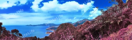 Beautiful purple and pink infrared panorama of a landscape on the Seychelles Islands.