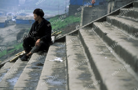 a worker at the city of wushan on the yangzee river near the three gorges valley up of the three gorges dam project in the province of hubei in china.