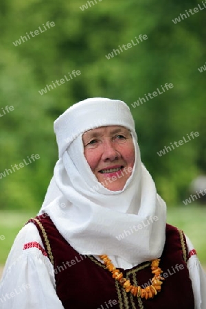 a Women in traditional dress on a Summer Festival in a Parc in the old City of Vilnius in the Baltic State of Lithuania,  