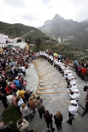 Swiss Alphorn player in the  mountain Village of  Tejeda in the centre of the Canary Island of Spain in the Atlantic ocean.
