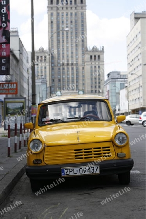 a old car in front of the Culture Palace in the City of Warsaw in Poland.