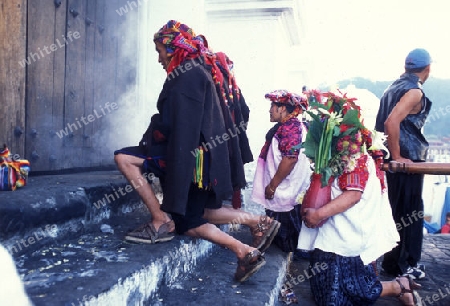 A relogion  procession with people in traditional clotes at the Market in the Village of  Chichi or Chichicastenango in Guatemala in central America.   