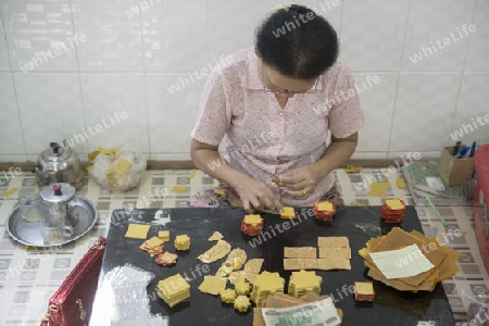 women control the sheets of Gold leaf at a Gold pounder Factory the City of Mandalay in Myanmar in Southeastasia.