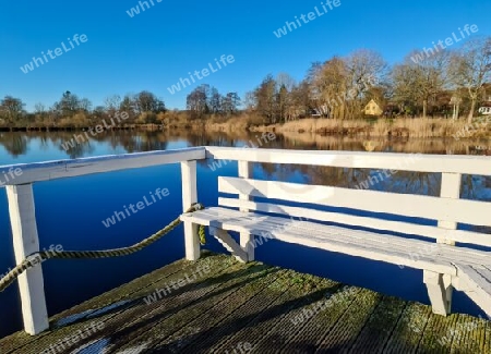 Beautiful landscape on a jetty by a lake with blue sky