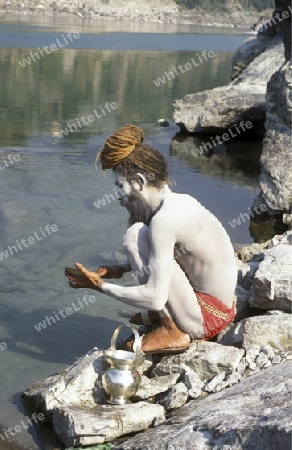 a men on the Ganges River in the town of Rishikesh in the Province Uttar Pradesh in India.