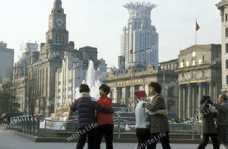 people dancing in the morning on the Bund in front of the skyline of Pudong in the City Shanghai in China.