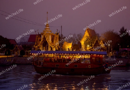 A smal Temple and a Evening Tour Boat on the River Chao Phraya in City of Ayutthaya in the north of Bangkok in Thailand, Southeastasia.