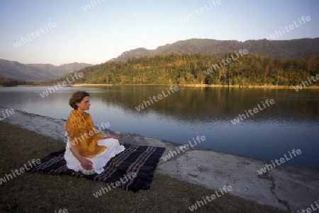 a women on the Ganges River in the town of Rishikesh in the Province Uttar Pradesh in India.
