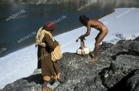 two men on the Ganges River in the town of Rishikesh in the Province Uttar Pradesh in India.