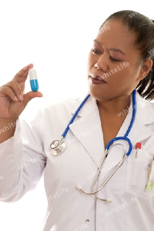 Health care worker holding  a large pill