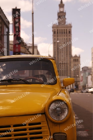 a old car in front of the Culture Palace in the City of Warsaw in Poland.