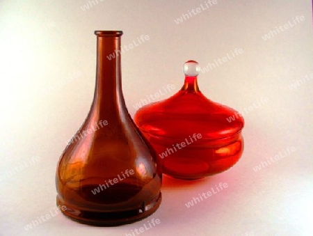Brown Glass Bottle and Red Jar Still life