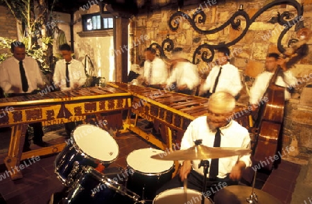 A traditional Music Band plays in a Restaurant in the old city in the town of Antigua in Guatemala in central America.   