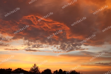 Beautiful orange and yellow clouds at sunrise and sunset in the sky