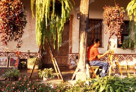 a painter in the old town in the city of Antigua in Guatemala in central America.   