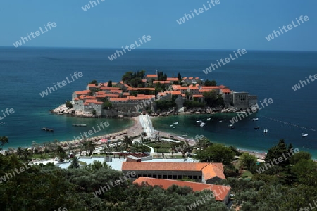 Die Altstadtinsel von Sveti Stefan in der Adria an der Kueste in Montenegro im Balkan am Mittelmeer in Europa.