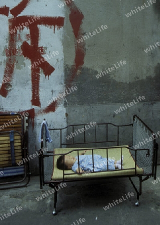 a baby sleeps in the City of Shanghai in china in east asia. 