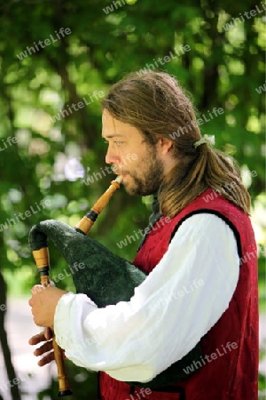 a men in traditional dress on a Summer Festival in a Parc in the old City of Vilnius in the Baltic State of Lithuania,  
