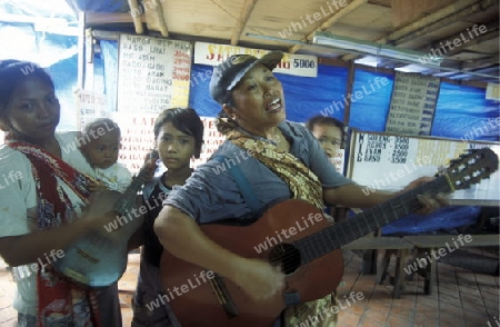 a Family plays Music in a Market in the city centre of Jakarta in Indonesia in Southeastasia.