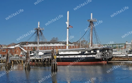 sailing ship named "USS Constitution" anchoring in Boston (Massachusetts, USA) at winter time in sunny ambiance