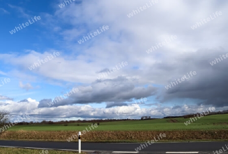 Beautiful clouds in a blue sky over a northern european landscape