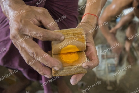 sheets of Gold leaf at a Gold pounder Factory the City of Mandalay in Myanmar in Southeastasia.