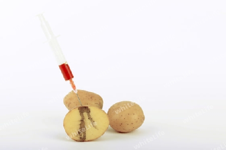 Spritze in Kartoffel, Symbolbild Genkartoffel, Injektionsspuren in der Kartoffel,  genmanipulierte Lebensmittel
