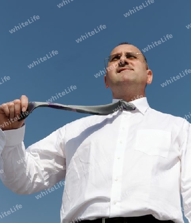 angry businessman hold his tie