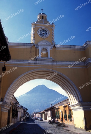 teh volcano agua and the arco de santa catalina in the old town in the city of Antigua in Guatemala in central America.   