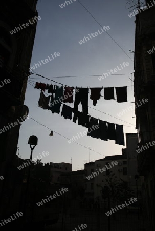 Clothes hanging over the streets in the old Town of Catania in Sicily in south Italy in Europe.