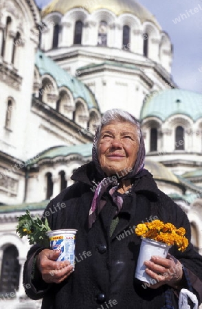 a women sales flowers at the Nevski church in the city of Sofia in Bulgaria in east Europe.