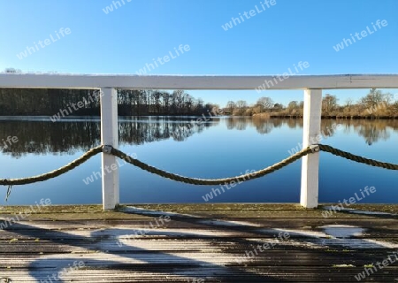 Beautiful landscape on a jetty by a lake with blue sky
