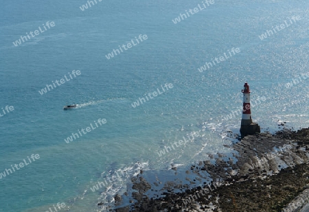 aerial shot of a lighthouse and Boat near Beachy Head in England at summer time