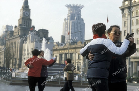 people dancing in the morning on the Bund in the City Shanghai in China.