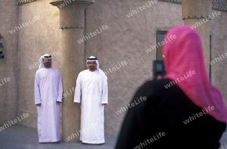 a portrait of a Arab men in the souq or Market in the old town in the city of Dubai in the Arab Emirates in the Gulf of Arabia.