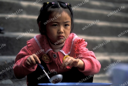 a child is cocking at the city of wushan on the yangzee river near the three gorges valley up of the three gorges dam project in the province of hubei in china.
