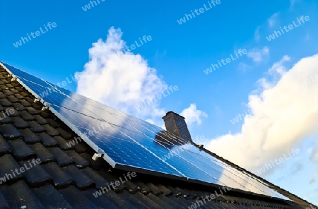 Solar panels producing clean energy on a roof of a residential house